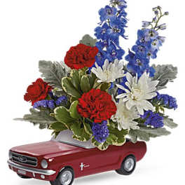 Floral arrangement in a red car-shaped container