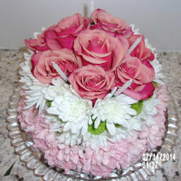 Pink roses and white daisies arranged on a glass platter