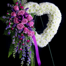 Heart-shaped floral wreath with pink roses and white chrysanthemums