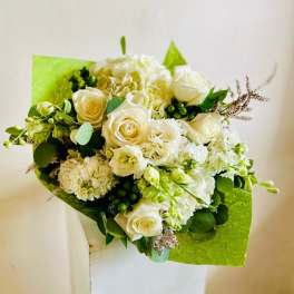White roses and hydrangeas in bright green wrapping