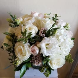 White rose and hydrangea bouquet with pale pink accents