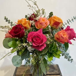 Bouquet of multicolored roses in a glass vase
