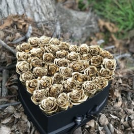 Heart-shaped box filled with gold roses