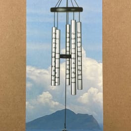 Silver wind chime with a cross pendant on a printed card