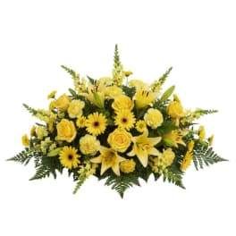 Yellow floral centerpiece with roses, lilies, and daisies