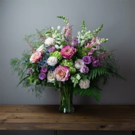 Mixed pink, purple, and white bouquet in a glass vase