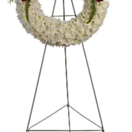 Standing funeral wreath with red and white flowers on an easel