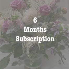 Pastel bouquet of pink roses and white dahlias in a glass vase with six months subscription text overlay