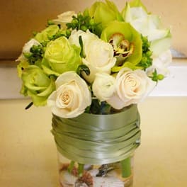 Bouquet of white and green roses in a glass vase