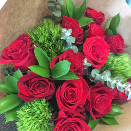 Bouquet of red roses with green filler and brown wrapping