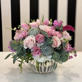 Pink and white floral arrangement in a clear glass vase