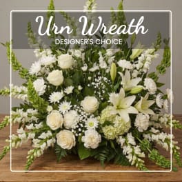 White floral wreath with roses, lilies, and snapdragons