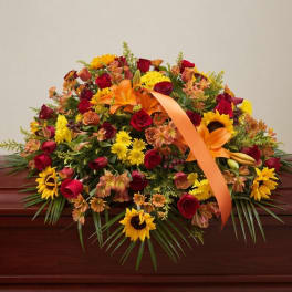 Mixed bouquet with red roses, orange lilies, and yellow sunflowers