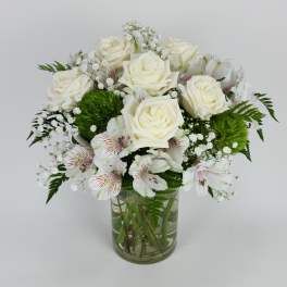 White roses and alstroemeria in a clear glass vase