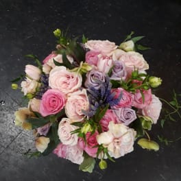 Bouquet of pink and lavender roses with purple accents