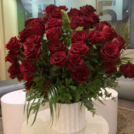 Large bouquet of red roses in a white vase