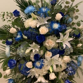 Blue and white floral standing spray with roses and lilies