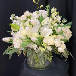 White floral arrangement in a clear glass vase