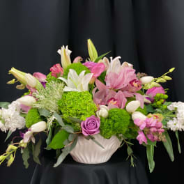 Pink and white floral arrangement in a white vase