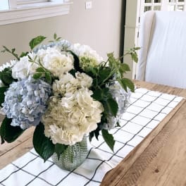 Hydrangea bouquet in a glass vase on a dining table