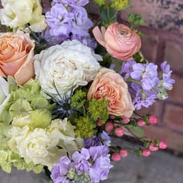 Bouquet of peach and white roses with lavender flowers
