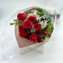 Bouquet of red roses with white baby's breath in clear wrap