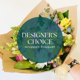 Wrapped bouquet of mixed pastel flowers with brown paper