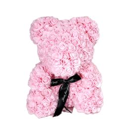 Pink teddy bear made of roses with a black ribbon