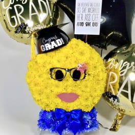 Yellow flower graduation face arrangement with balloons and a sign