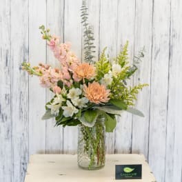 Pastel bouquet in a textured glass jar vase