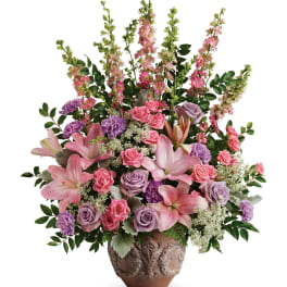 Pink and lavender floral arrangement in a decorative vase