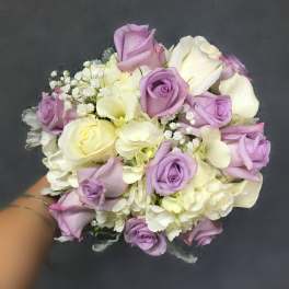 Bouquet of lavender and white roses with white filler flowers