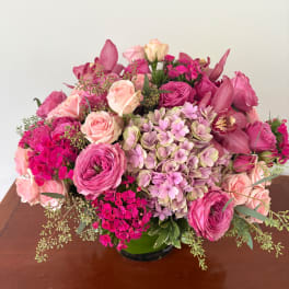 Pink mixed flower arrangement in a low vase