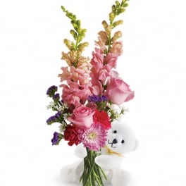 Pink mixed flower bouquet with a white teddy bear