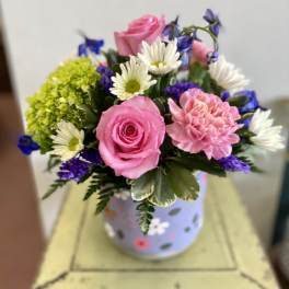 Pink roses and carnations with white daisies in a decorated vase