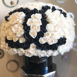 Black and white rose bouquet in a black vase