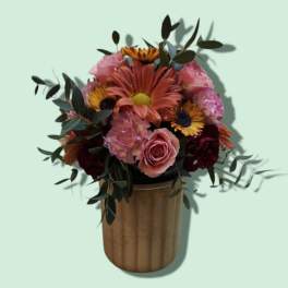 Mixed bouquet in a gold vase with pink and orange flowers