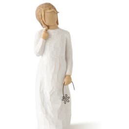 Wooden figurine in a white dress holding a small flower charm