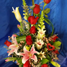 basket with red roses and lilies