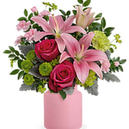 Pink lilies and roses in a pink vase