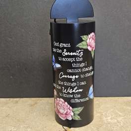 Black cylindrical holder with a Serenity prayer and butterfly and flower designs