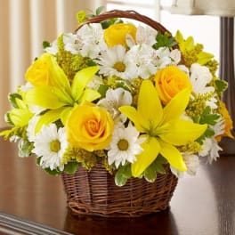Yellow roses and white daisies in a wicker basket