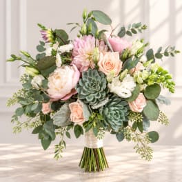 Wedding bouquet with blush roses, pale pink blooms, and succulents