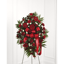 Red floral standing spray with ribbon on an easel