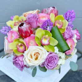 Bouquet of pink and white roses with green orchids and purple flowers