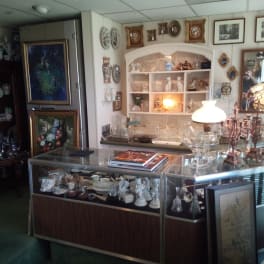 Antique shop interior with glass display cases and decorative lamps