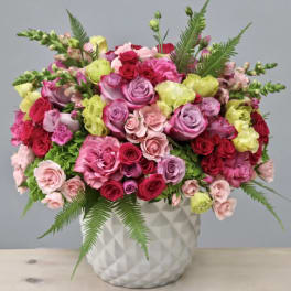 Mixed pink and red roses in a white textured vase