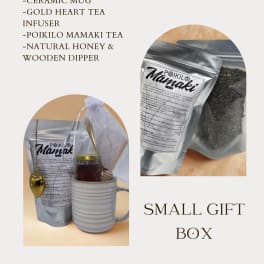 Small gift box with a ceramic mug, tea, honey, and a gold heart infuser