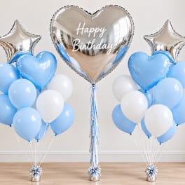 Blue and white birthday balloon display with silver heart and star balloons
