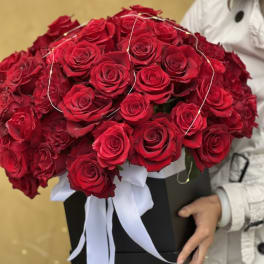 Large bouquet of red roses in a black box with a white ribbon